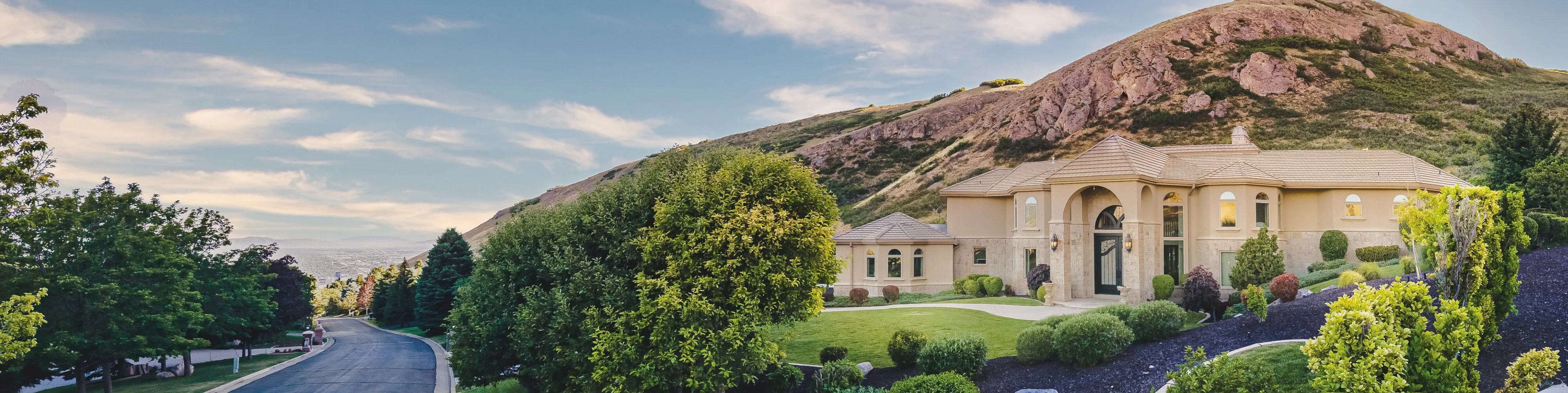 Panoramic view of the estate beneath the foothills with storm light over the valley